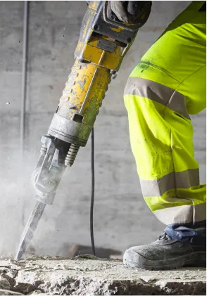 A professional worker drilling cement